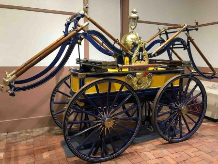 Newly restored pumper in museum, painted yellow and blue