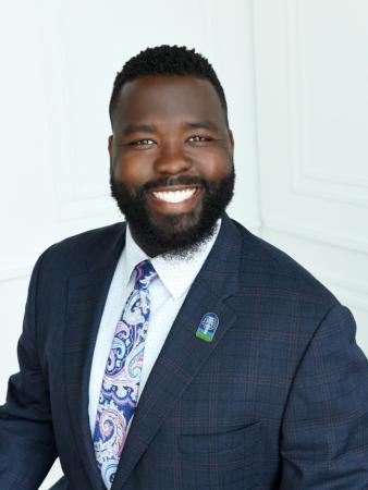 picture of man smiling against a plain background