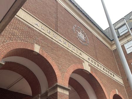 red brick arches with City of Alexandria seal and letters reading Alexandria Courthouse above