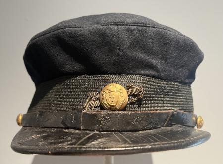 Cap with brass button insignia
