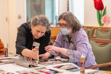 Two people working on quilt