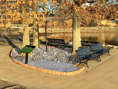 picture of a park with benches, commemorative bricks and a sign