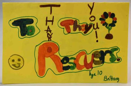 A card made for the 9/11 rescuers, with a colorful message drawn in markers, “Thank you to the Rescuers, Age 10, Brittany.”