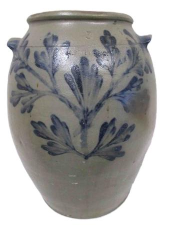 An ovoid grey salt-glazed stoneware jar with lug-handles is decorated with a brushed cobalt blue central flower on a straight stem, with straight branches springing from the stem’s base at a 45-degree angle. The decoration is similar to that on the only known piece marked with David Jarbour’s name. It is stamped H. SMITH & CO. with a 3-gallon capacity mark.