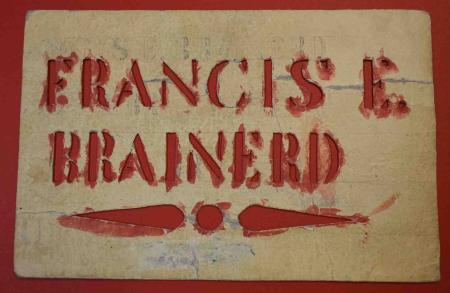 A stencil with the name Francis E. Brainerd bears red paint from its use during the Civil War.