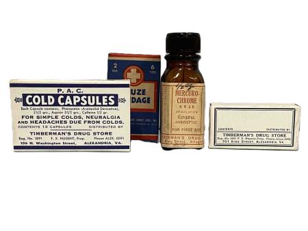 Cold capsules, mercurochrome and a small rectangular box are labelled Timberman’s Drug Store, 701 King Street, Alexandria, VA., while a gauze bandage is wrapped in the manufacturer’s packaging