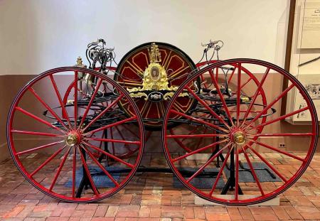 Restored hose reel carriage, painted red and gold