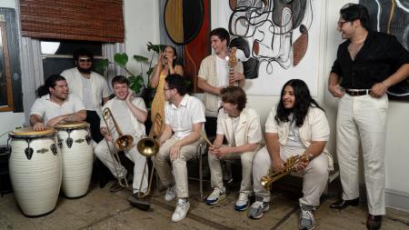 band in all white smiling in a group