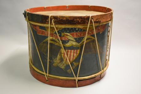 The drum is decorated with an American eagle and the words “Regimental Infantry in gold on a red ribbon.