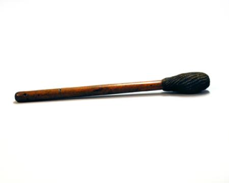 A wooden drum-stick with a large head.