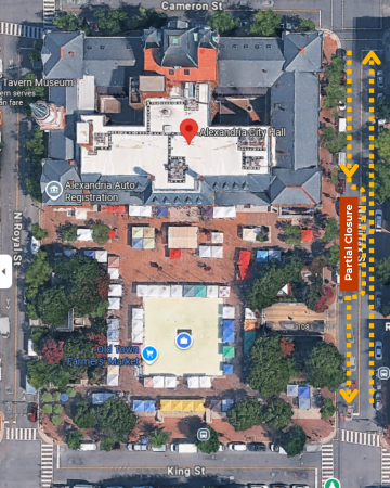 Aerial view of the Alexandria City Hall and surrounding area. The image shows the Old Town Farmers Market with numerous vendor tents set up. Streets around the market include Cameron St, N Royal St, and King St. North Fairfax Sts is marked on the right side indicating "Partial Closure." Dashed yellow arrows pointing northbound and southbound on N Fairfax St show the flow of traffic around the southbound partial closure.