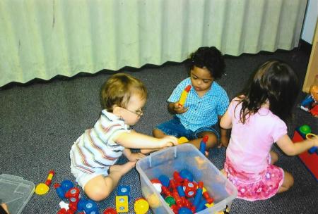 Hussein and others play with blocks.