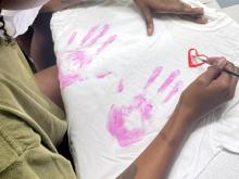 woman painting a white tshirt