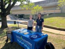 two city staff tabling at a metro station 