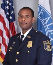 Portrait of Lt Dessalegn in front of flags.