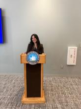 city employee on a podium with city seal 