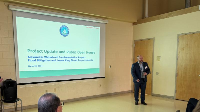 Photo of Project Manager Matt Landes standing in front of a large screen about to begin a presentation.