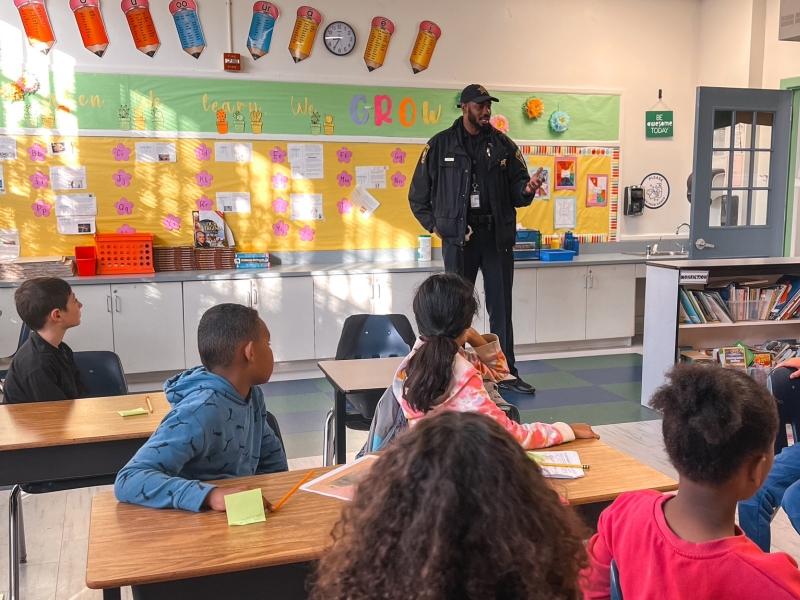 Deputy speaking to a class of elementary students